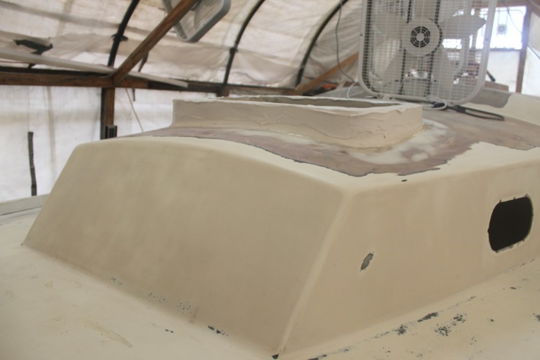 The new hatch flange for the Lewmar 54 Ocean hatch.  This is made from ~3 layers of marine plywood and a few layers of biaxial fiberglass.  This image shows a layer of fairing that hasn't been sanded down.
