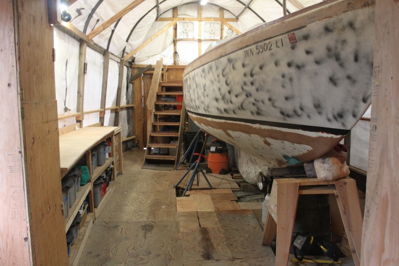 Floor space around boat is much improved.  That darn spray paint on the hull though - I will sand that off as soon as construction starts again!