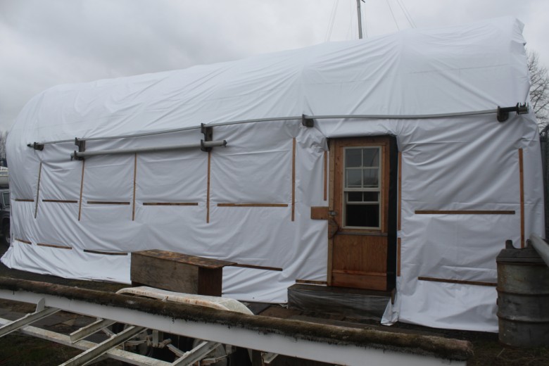 The east exterior of the boat shed.  Note the new tarp.  A new door was custom built by my Dad, that replaced the old screen door.